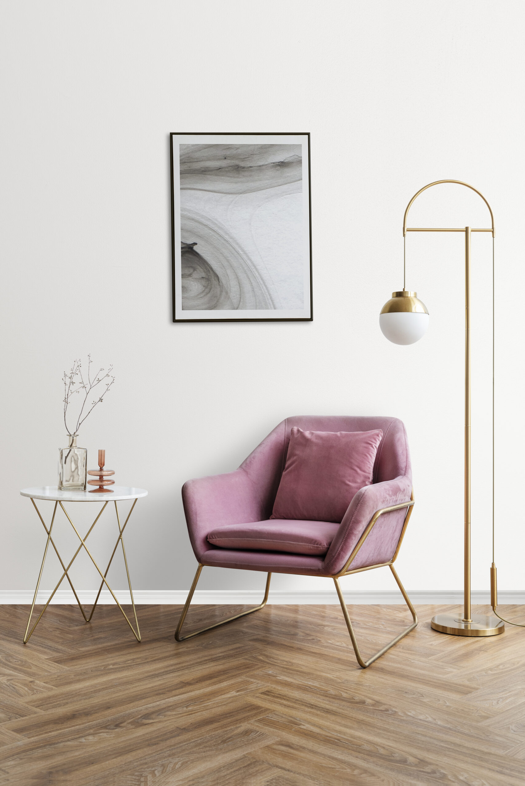 Picture frame with abstract art by a pink velvet armchair